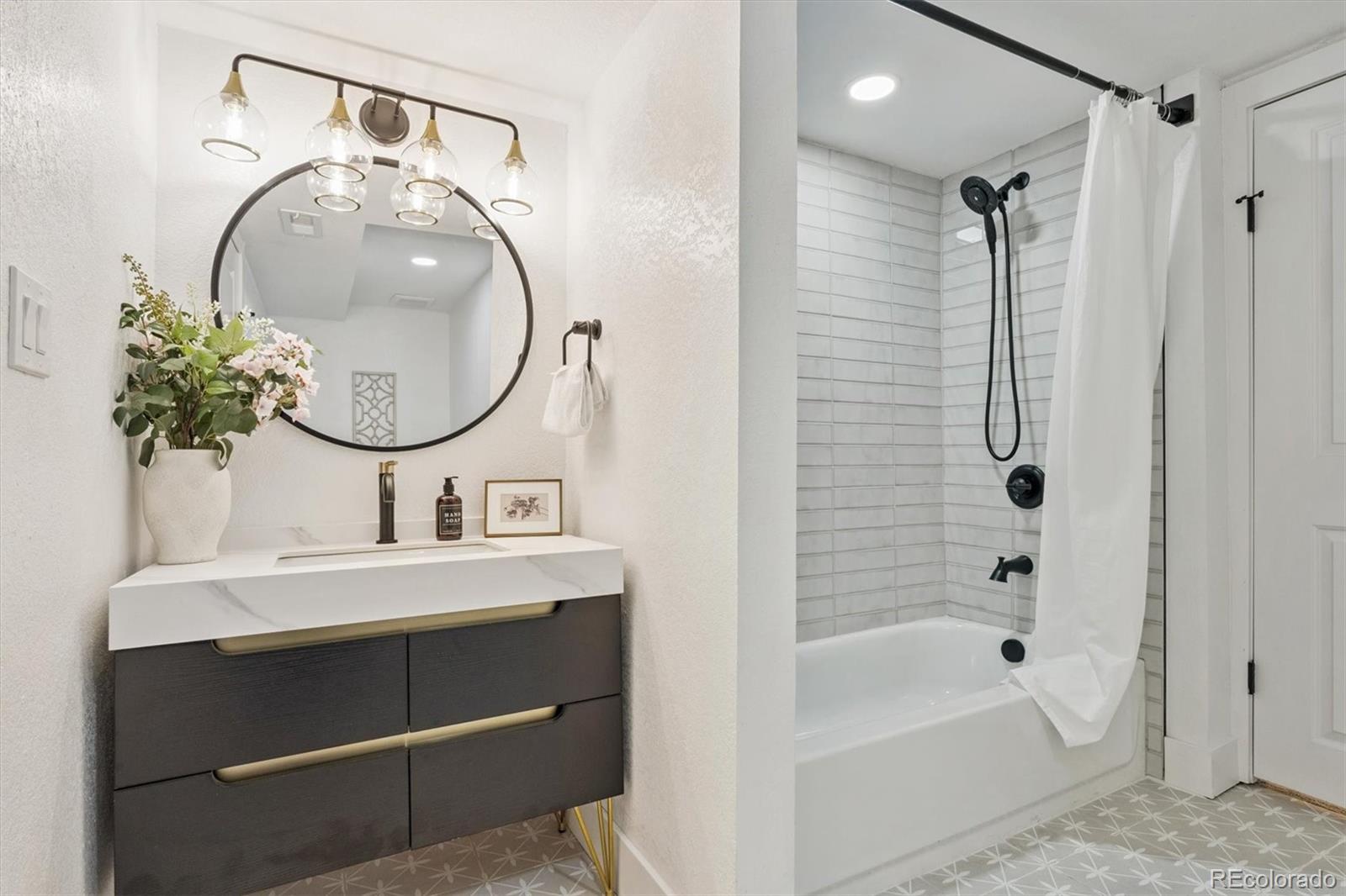3360 Broadway Boulder, CO 80304 - Photo 15 of 35 a bathroom with a sink a bathtub and a mirror