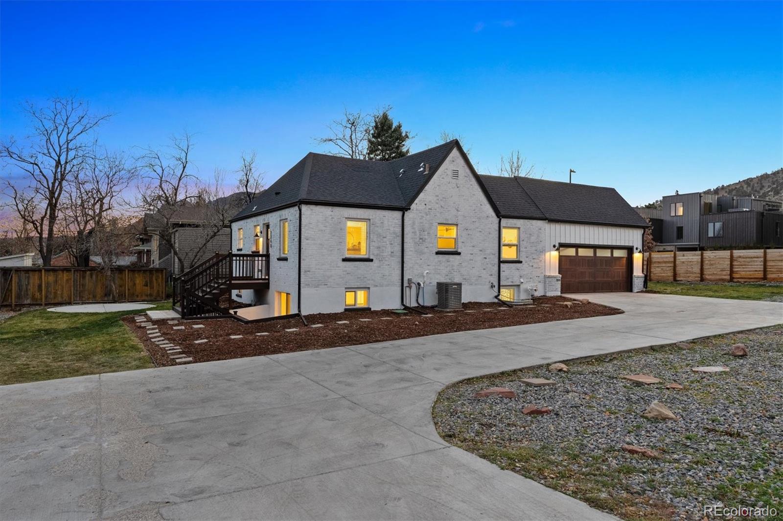 3360 Broadway Boulder, CO 80304 - Photo 24 of 35 a front view of a house with a yard and garage