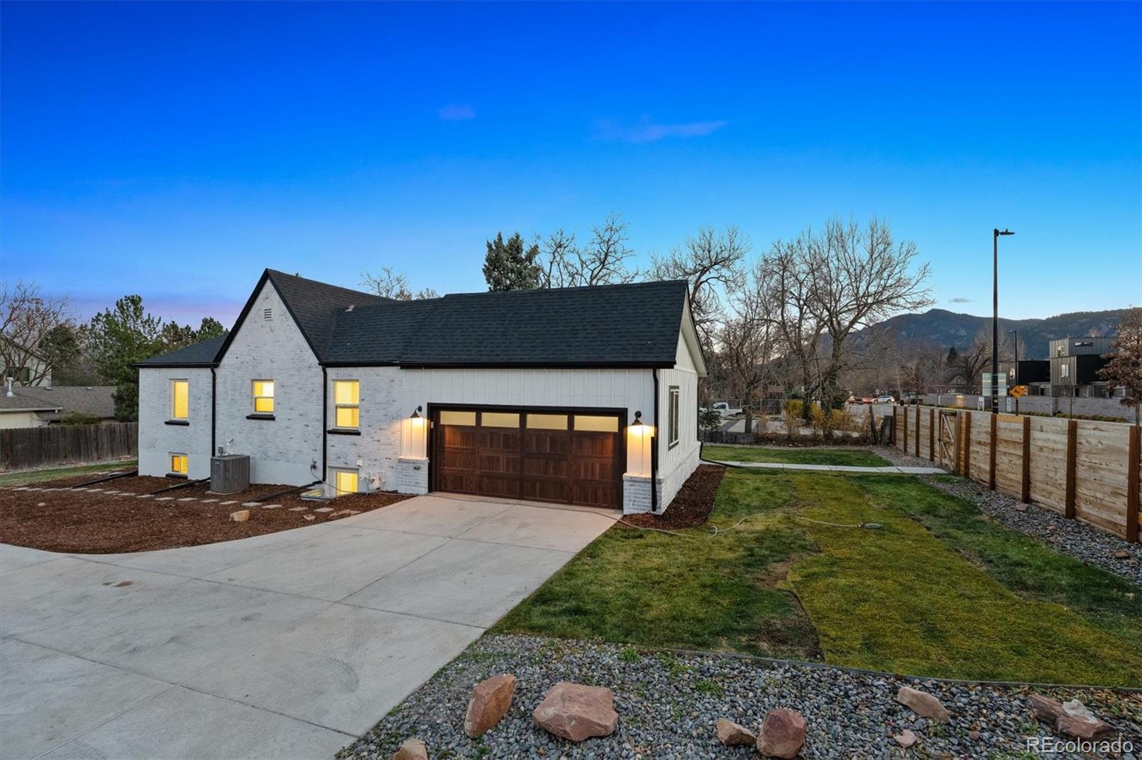 3360 Broadway Boulder, CO 80304 - Photo 26 of 35 a front view of a house with a yard and garage