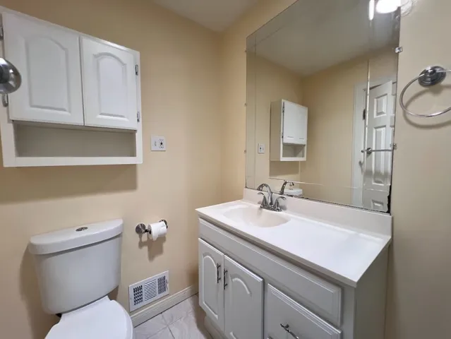 a bathroom with a sink toilet and mirror