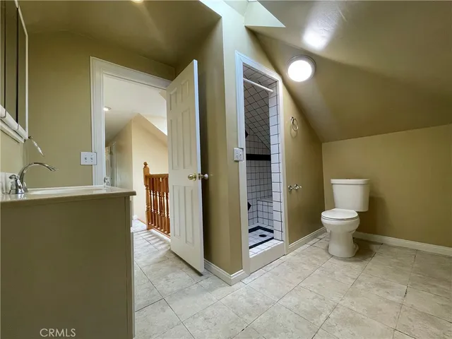 a bathroom with a toilet sink and shower