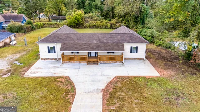 a aerial view of a house with swimming pool
