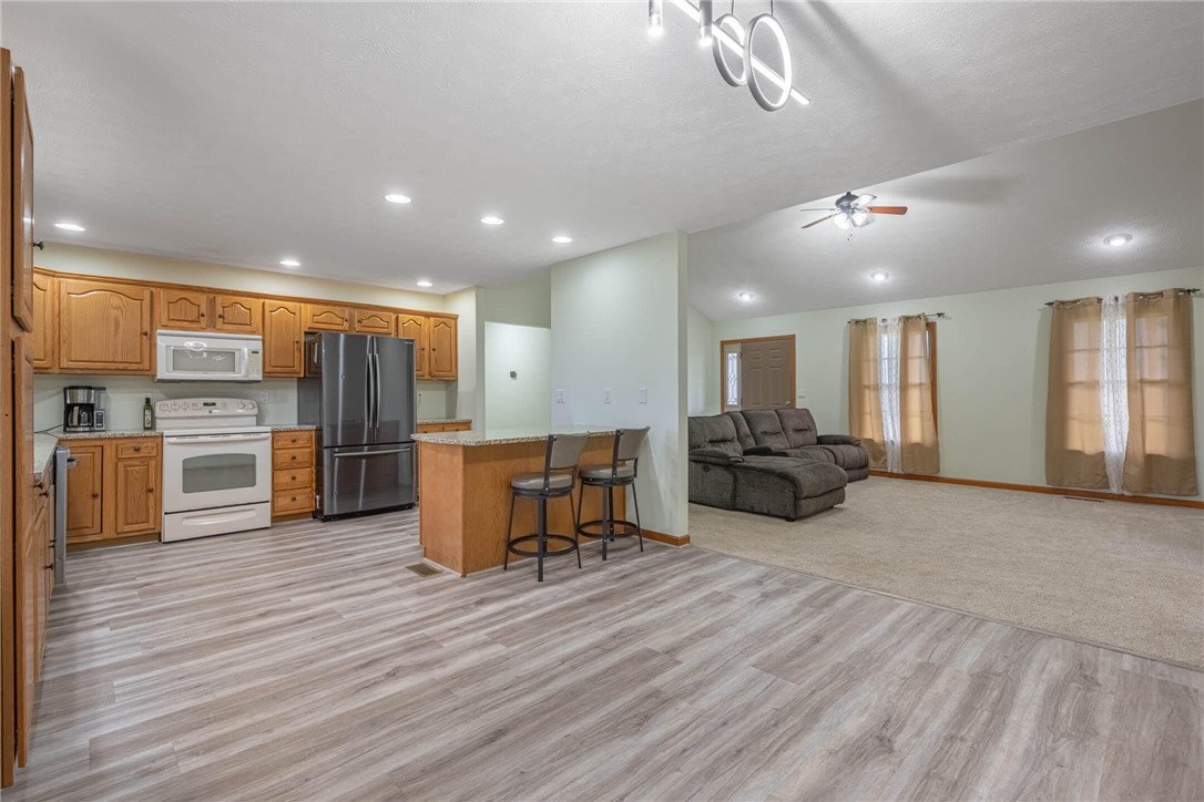 2645 Vance Road St. Paris, OH 43072 - Photo 7 of 35 This open-concept living space features a functional kitchen island and seamlessly connects to a cozy living area.