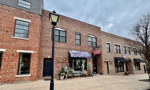 a front view of a brick building with many windows