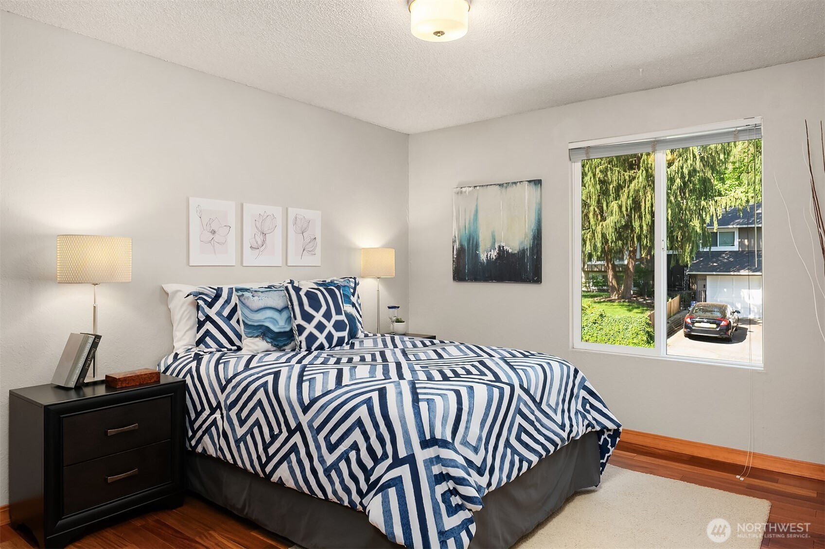 21331 2nd Avenue Southeast Bothell, WA 98021 - Photo 18 of 34 a bedroom with a bed and wooden floor