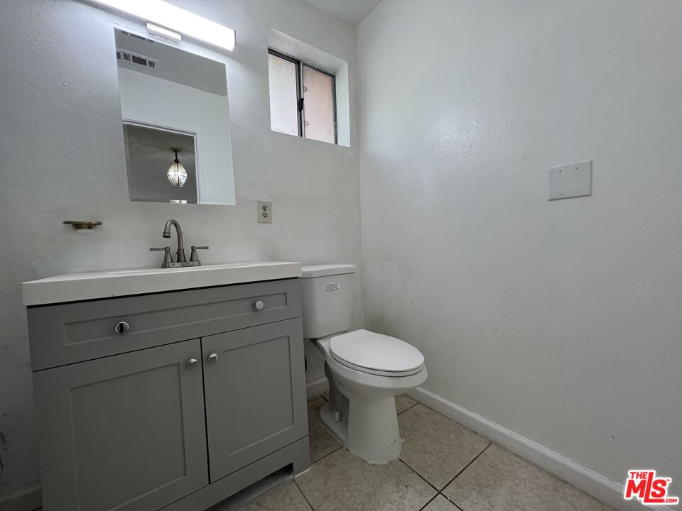 418 West Jackson Street Rialto, CA 92376 - Photo 23 of 24 a bathroom with a sink toilet and a mirror