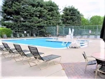 a view of a lake with table and chairs