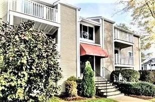 a front view of a house with plants