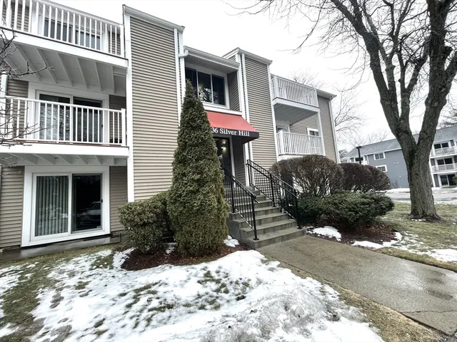 a view of a house with a yard covered in snow