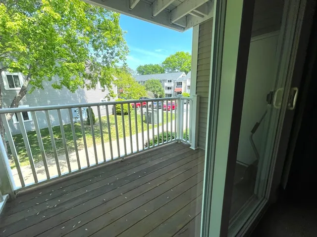 a view of balcony with wooden floor