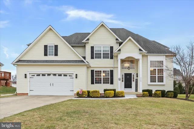 a view of a house with a yard and deck