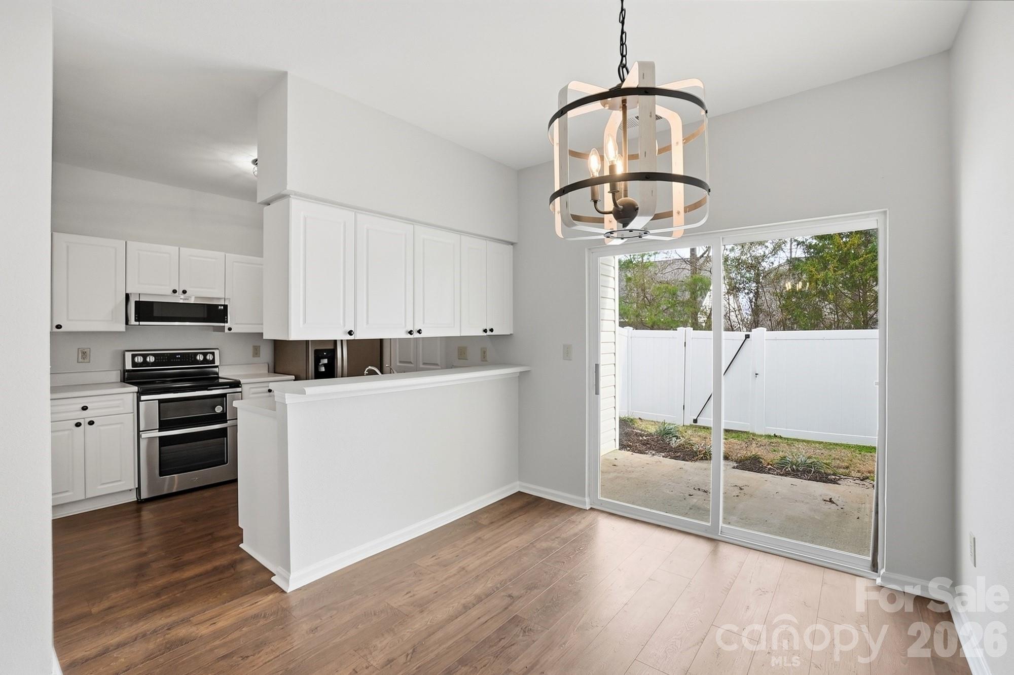 711 Stone Village Drive Fort Mill, SC 29708 - Photo 13 of 46 a kitchen with wooden floor and white appliances