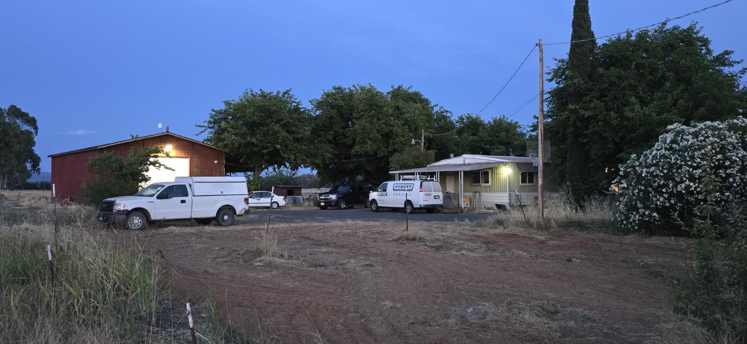a view of a house with a yard and sitting area