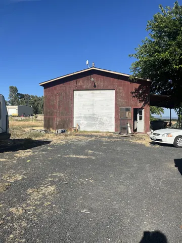 a view of garage with a car parked in it