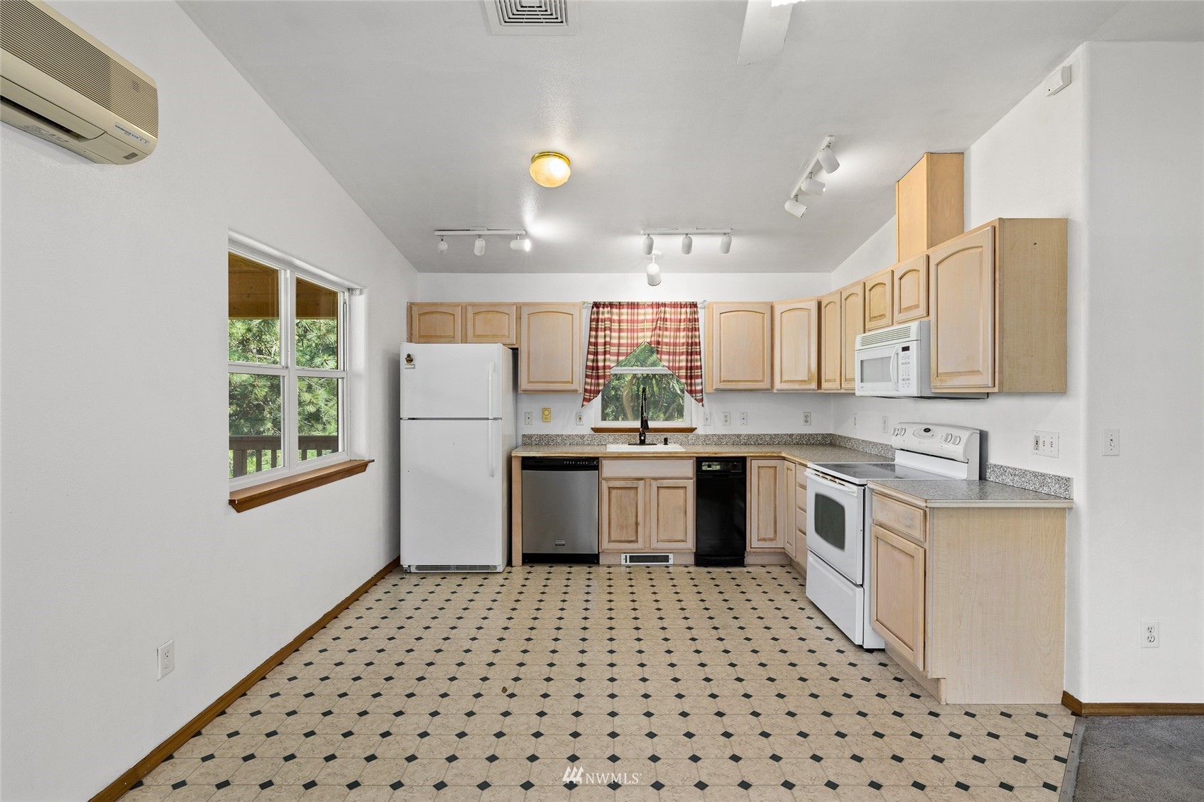 5741 Upper Peoh Point Road Cle Elum, WA 98922 - Photo 16 of 39 a kitchen with a refrigerator a sink and cabinets