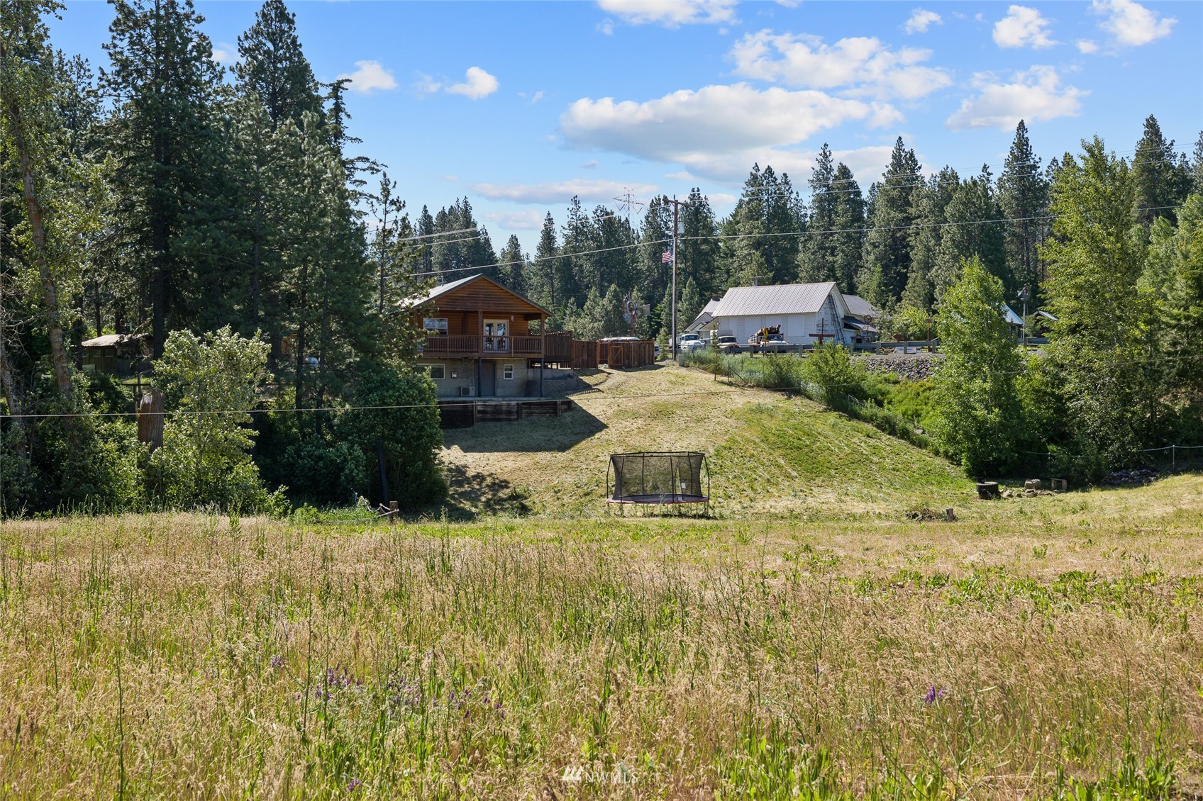 5741 Upper Peoh Point Road Cle Elum, WA 98922 - Photo 32 of 39 a front view of a house with a yard and trees