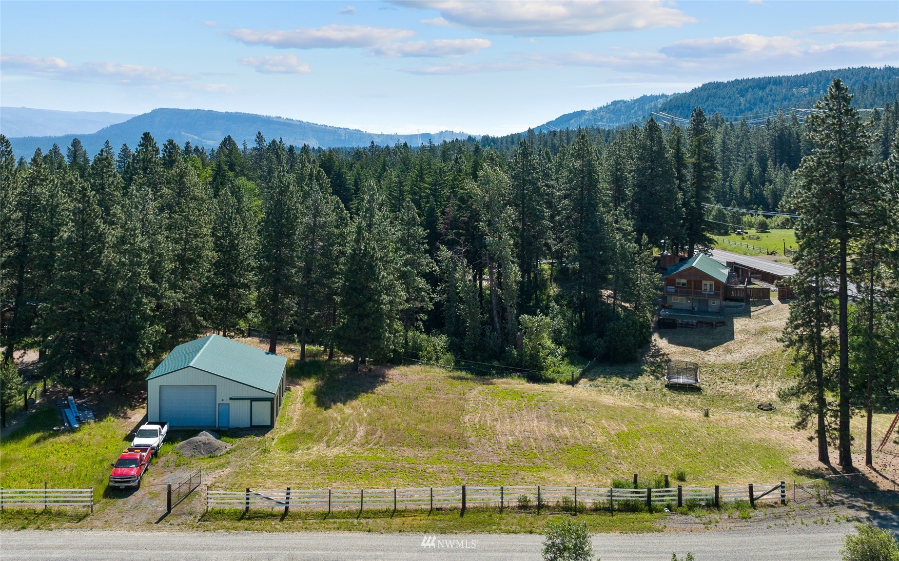 5741 Upper Peoh Point Road Cle Elum, WA 98922 - Photo 36 of 39 a view of a park with a bench under an umbrella