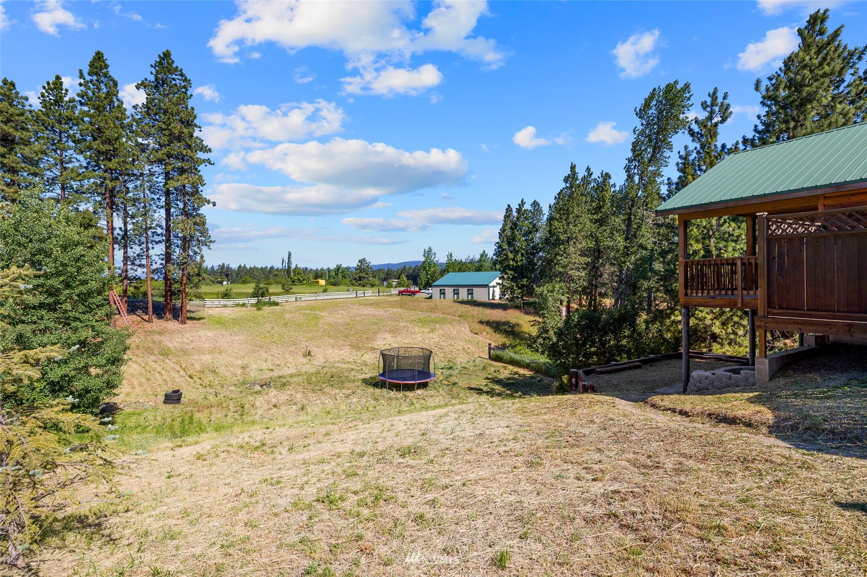 5741 Upper Peoh Point Road Cle Elum, WA 98922 - Photo 7 of 39 a view of a lake with a yard and a large tree