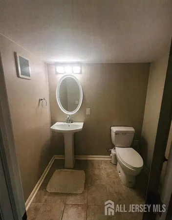 a bathroom with a toilet and a mirror