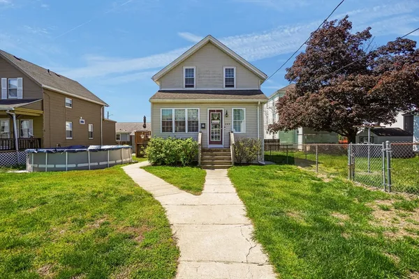 a front view of house with yard and green space