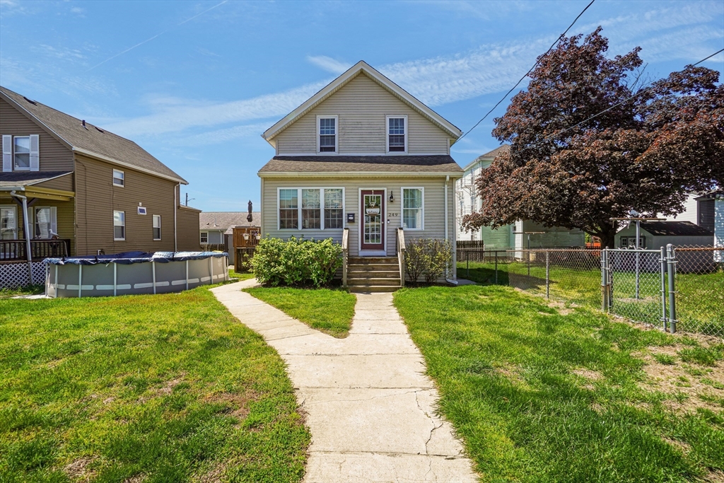 a front view of house with yard and green space