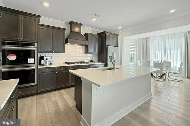 a kitchen with a sink a stove and cabinets