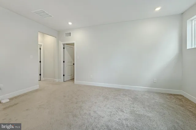 an empty room with windows and closet