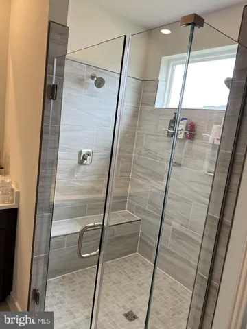 a large bed sitting in a bedroom next to a window