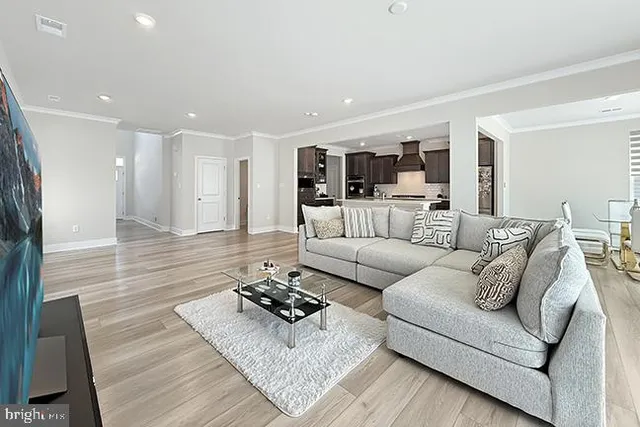 a living room with furniture rug and a table