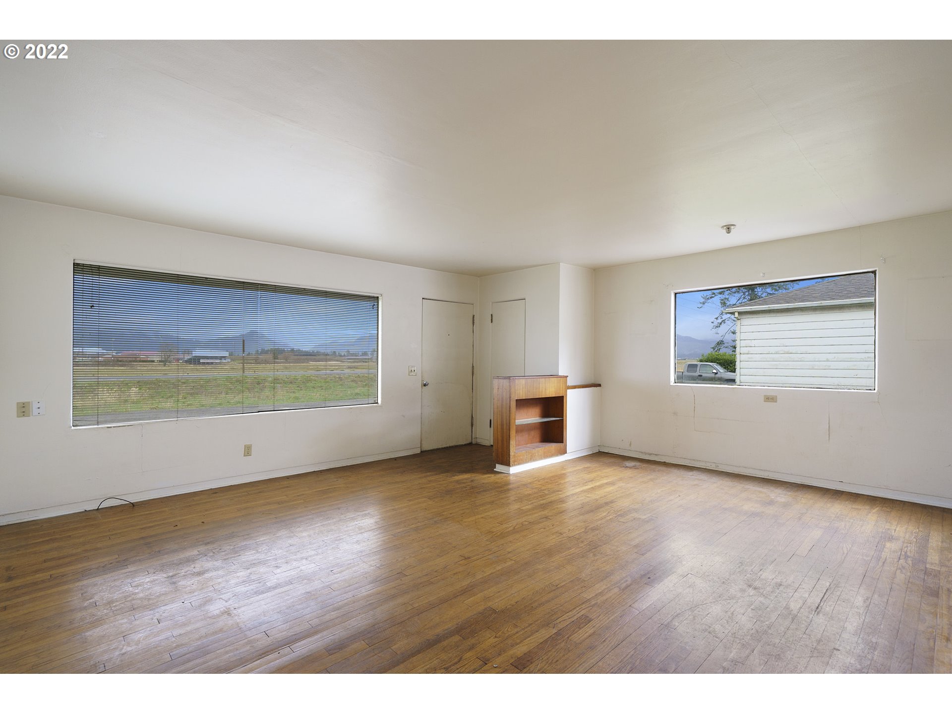 2255 Swett Acres Road Tillamook, OR 97141 - Photo 11 of 22 a view of an empty room with wooden floor and a window
