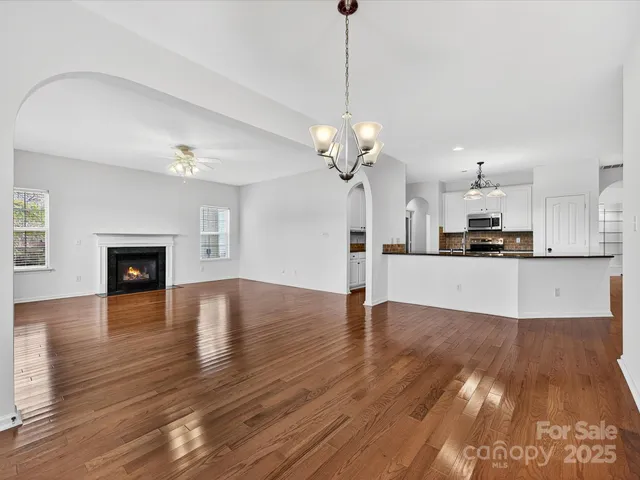 a view of a kitchen with stove and wooden floor