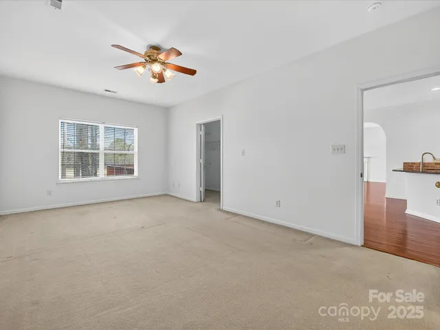 a view of a livingroom with a ceiling fan and window