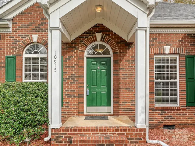 a view of a brick house with large windows