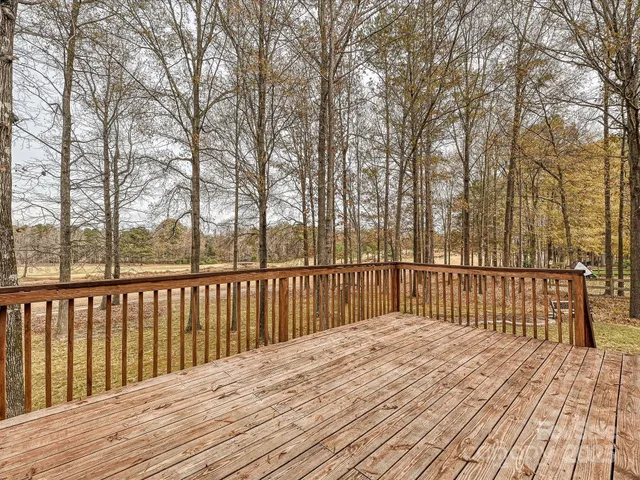 a balcony with wooden floor and fence