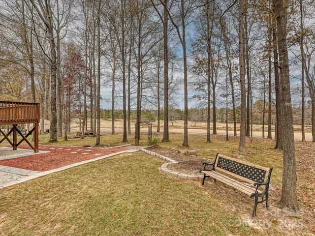 a swimming pool with outdoor seating and yard