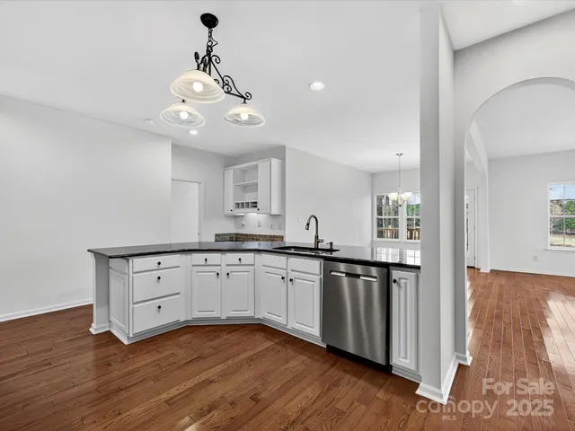 a kitchen with granite countertop cabinets a sink and dishwasher