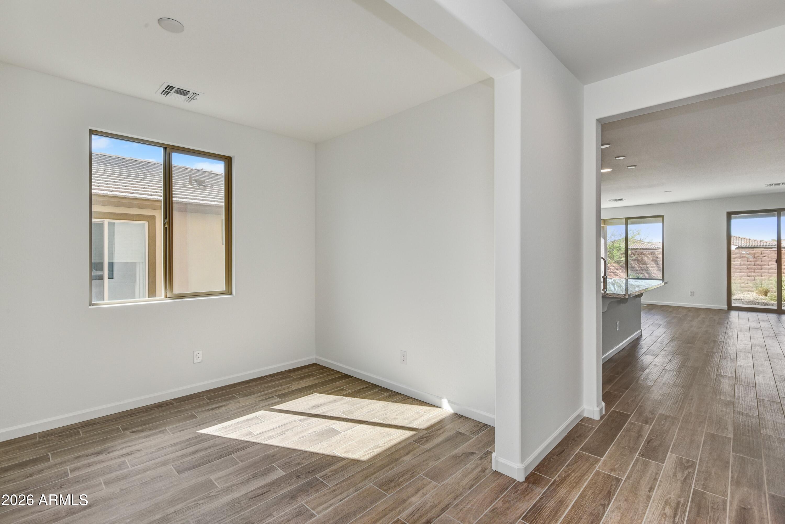 4522 Jackpot Road Wickenburg, AZ 85390 - Photo 11 of 22 a view of empty room with wooden floor and fan