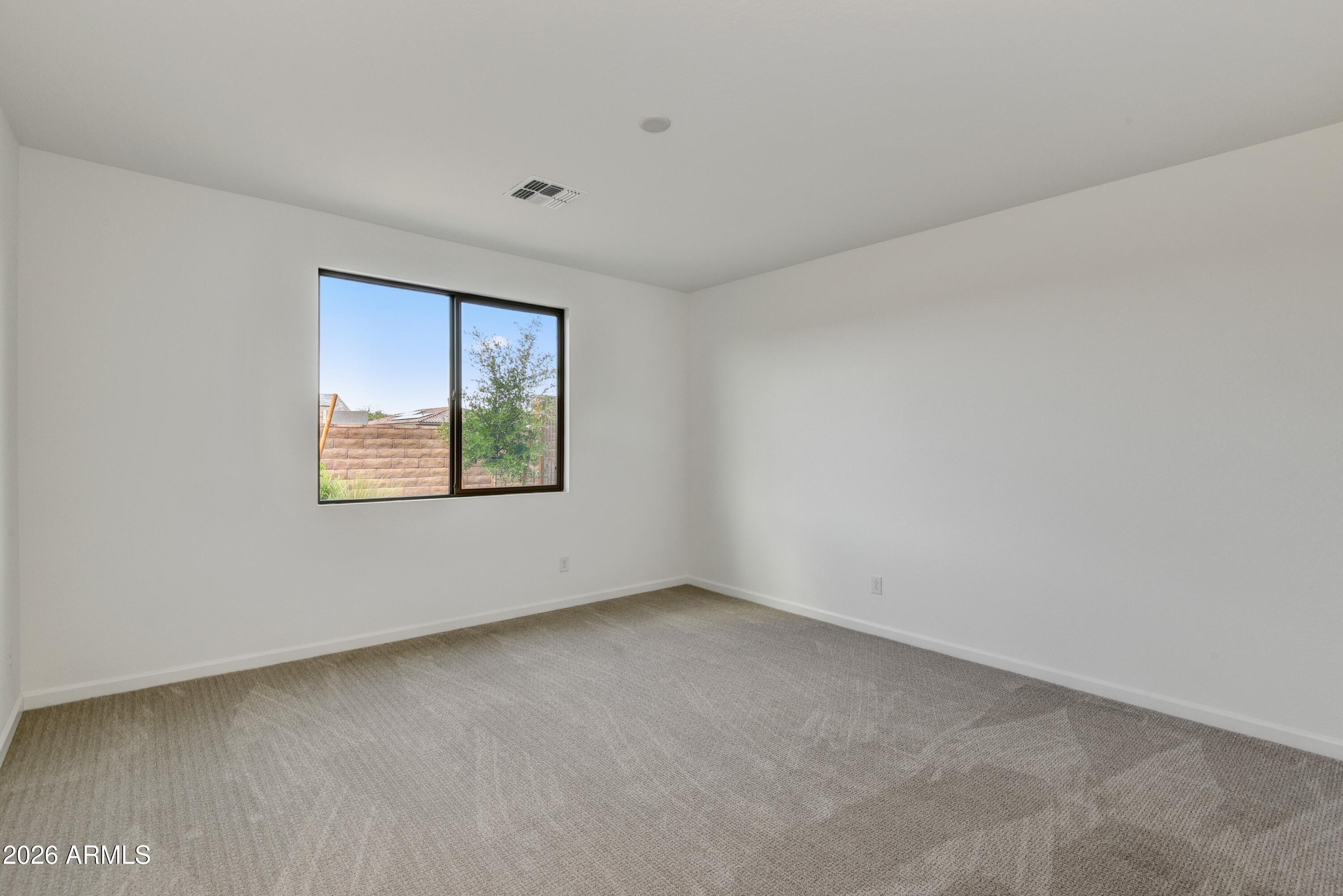4522 Jackpot Road Wickenburg, AZ 85390 - Photo 13 of 22 an empty room with a window