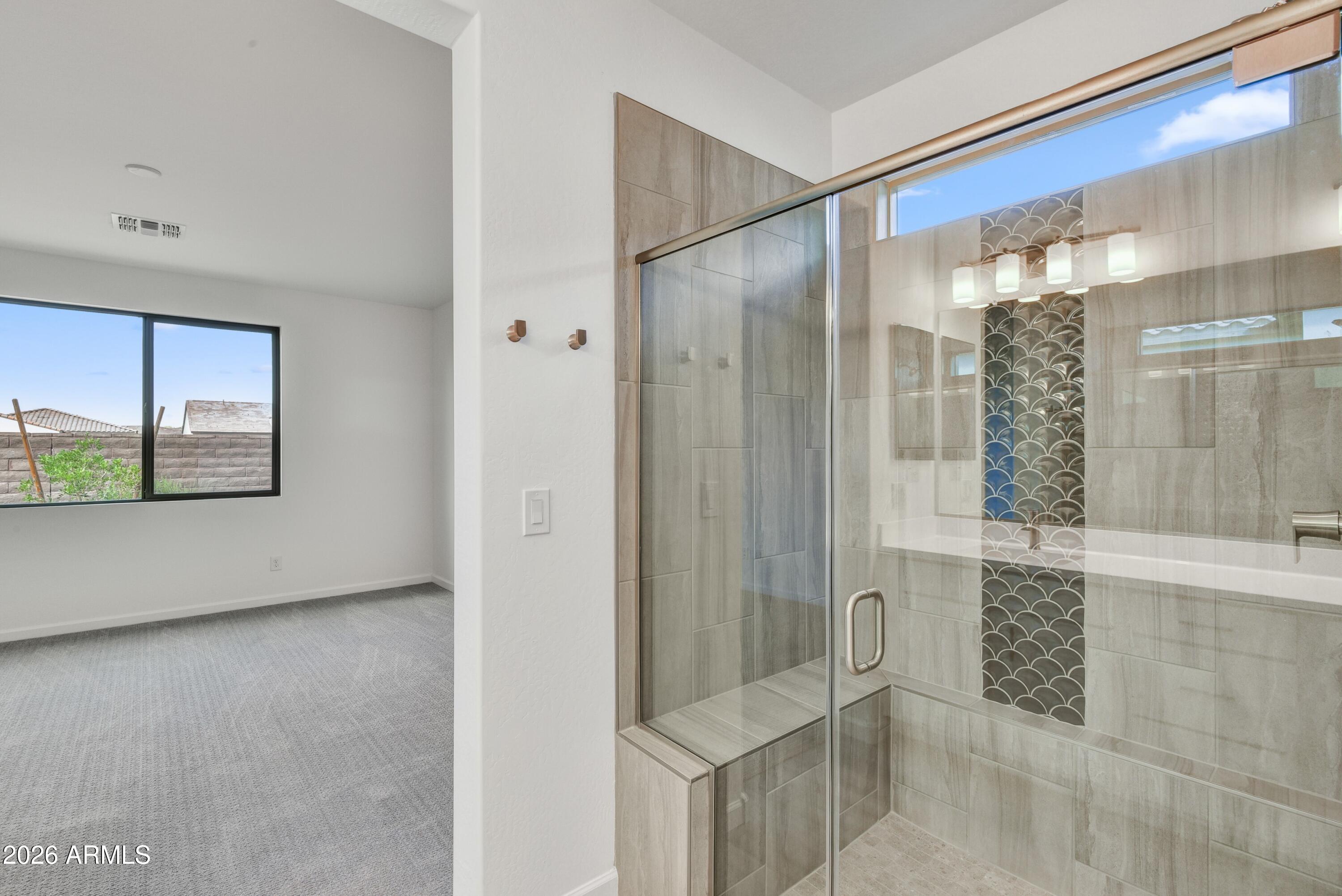 4522 Jackpot Road Wickenburg, AZ 85390 - Photo 15 of 22 a bathroom with a glass shower door