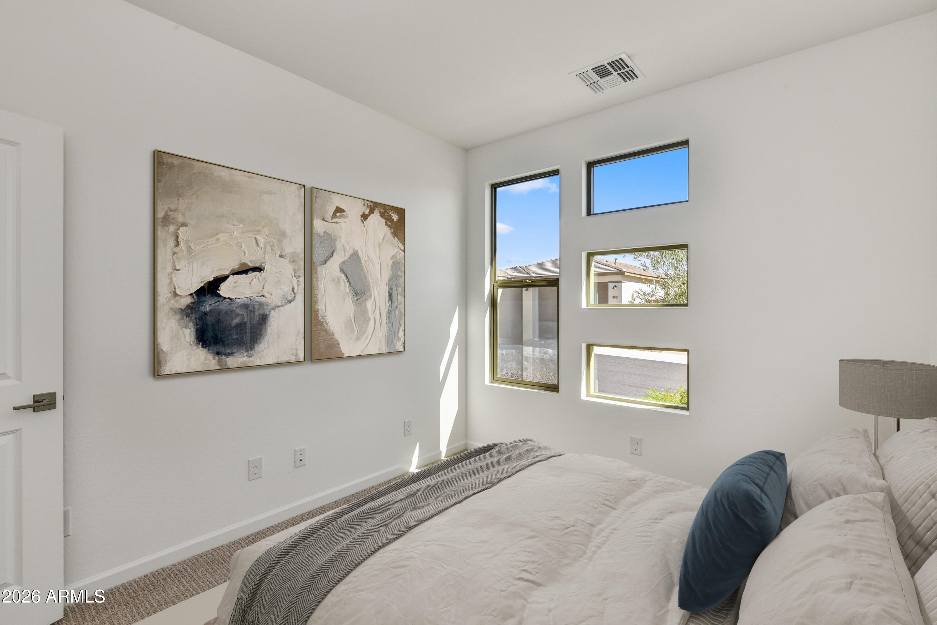 4522 Jackpot Road Wickenburg, AZ 85390 - Photo 16 of 22 a bedroom with a bed and a painting on the wall