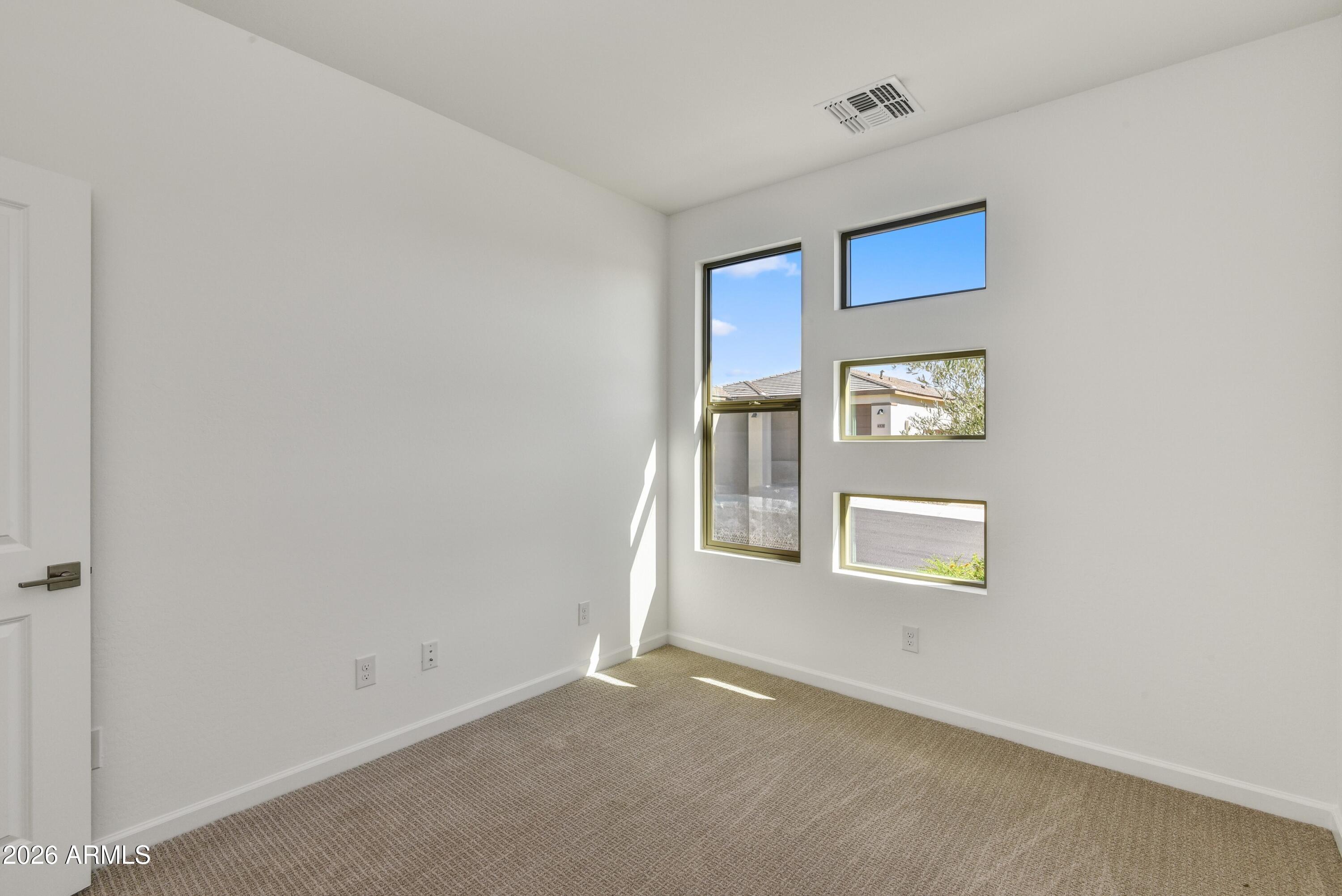 4522 Jackpot Road Wickenburg, AZ 85390 - Photo 17 of 22 an empty room with windows