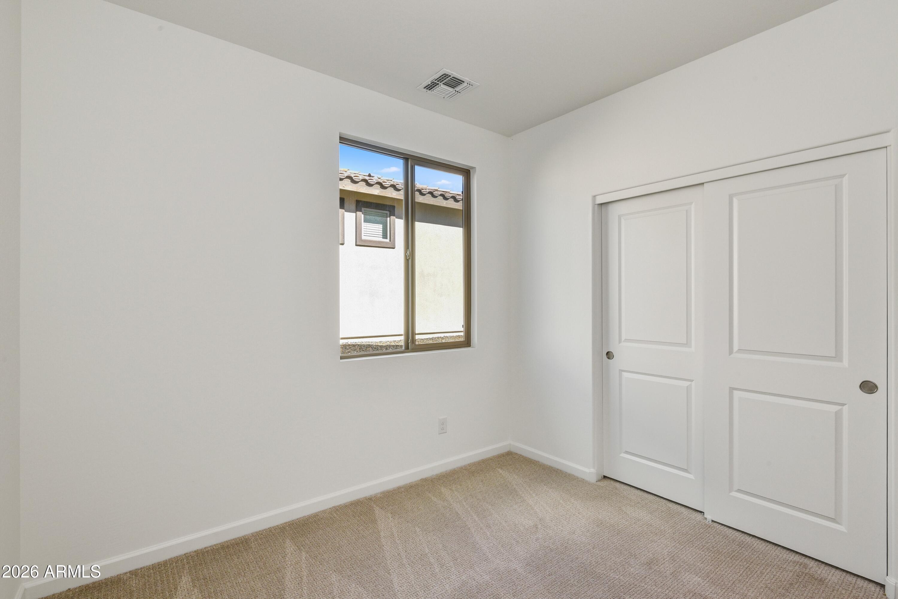 4522 Jackpot Road Wickenburg, AZ 85390 - Photo 18 of 22 an empty room with windows