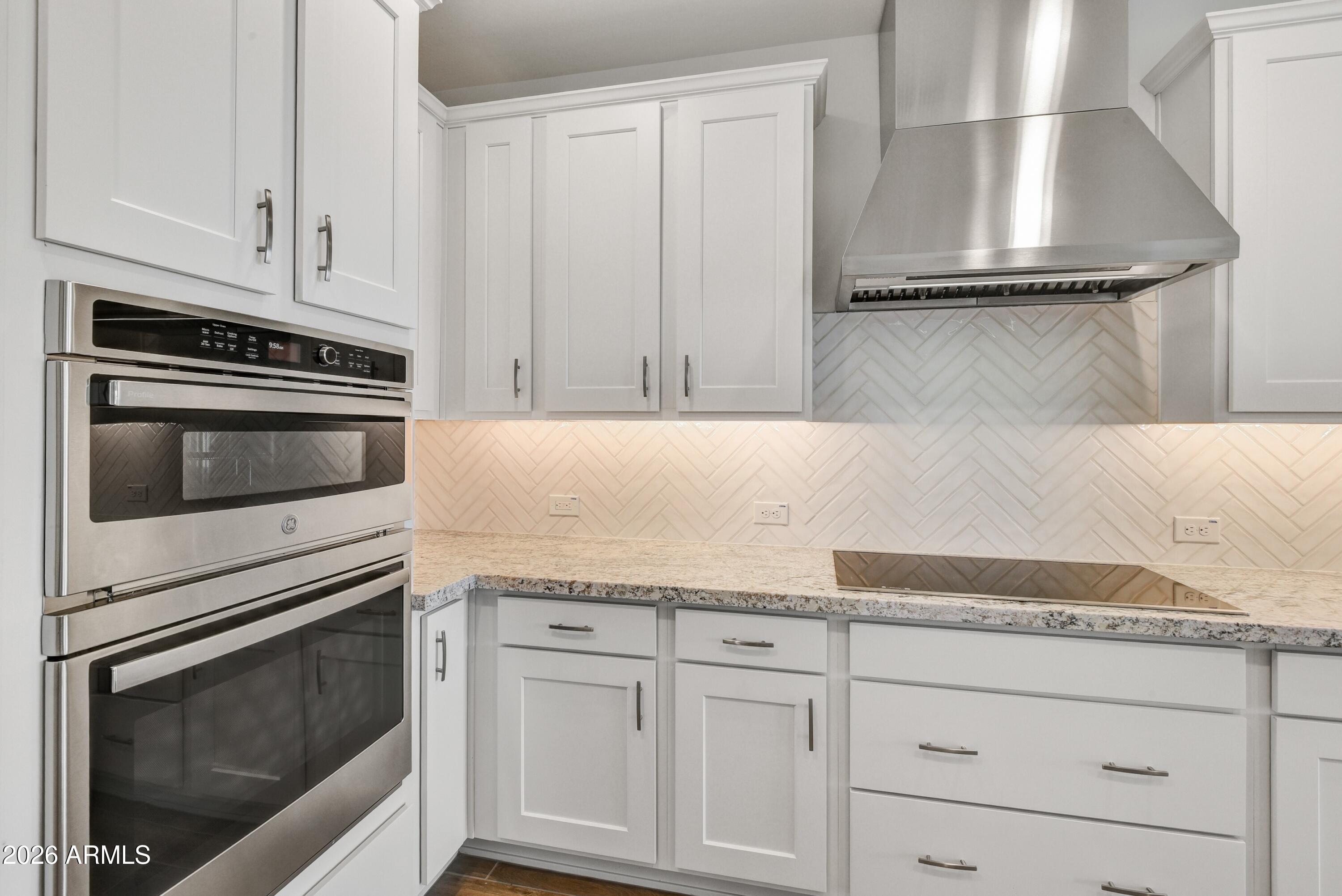 4522 Jackpot Road Wickenburg, AZ 85390 - Photo 6 of 22 a kitchen with granite countertop white cabinets and stainless steel appliances