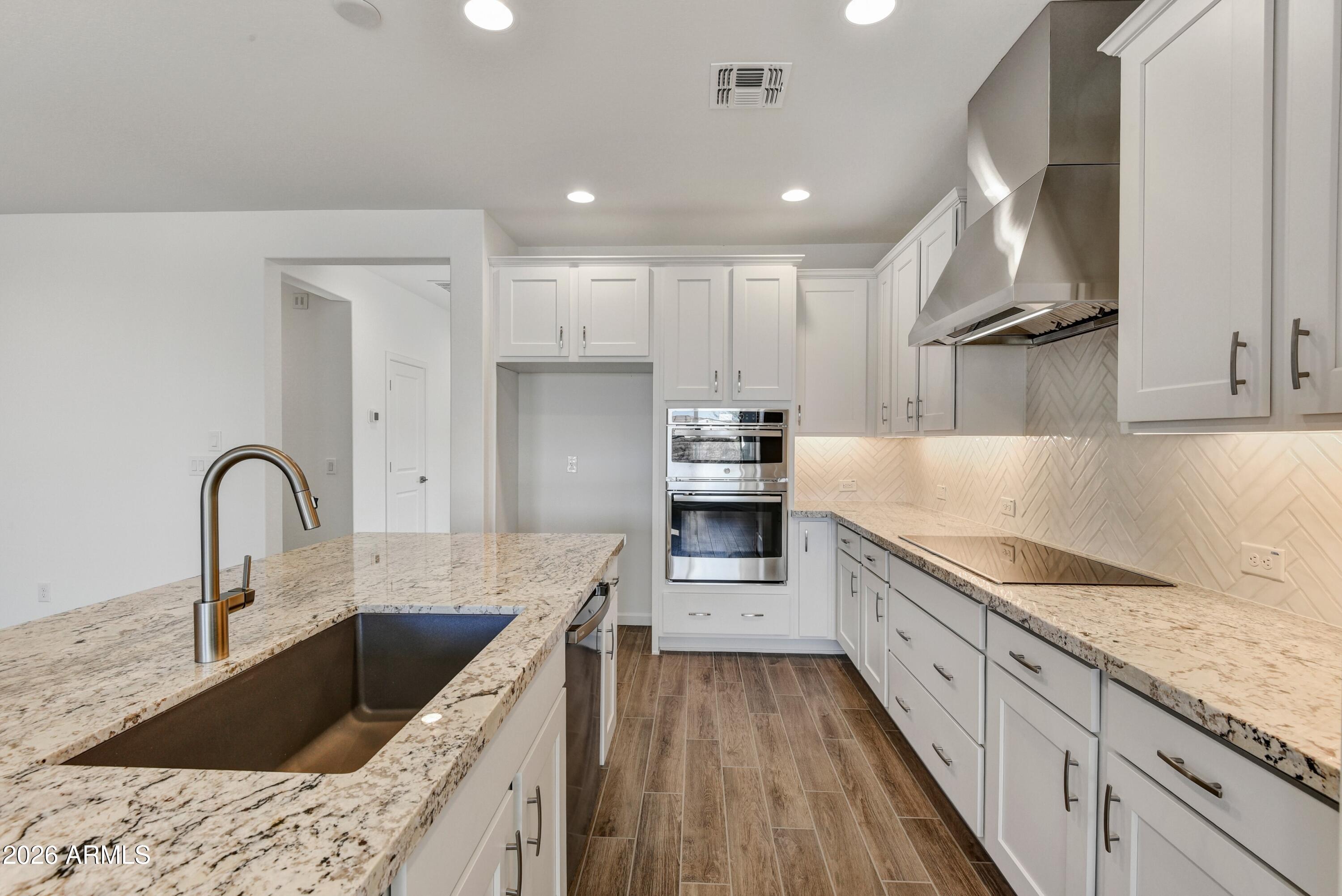 4522 Jackpot Road Wickenburg, AZ 85390 - Photo 7 of 22 a kitchen with stainless steel appliances granite countertop a sink stove and refrigerator