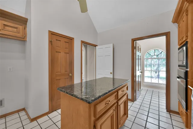 a kitchen with granite countertop a sink and a stove