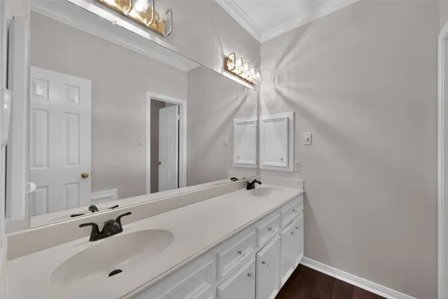 a bathroom with a double vanity sink and a mirror