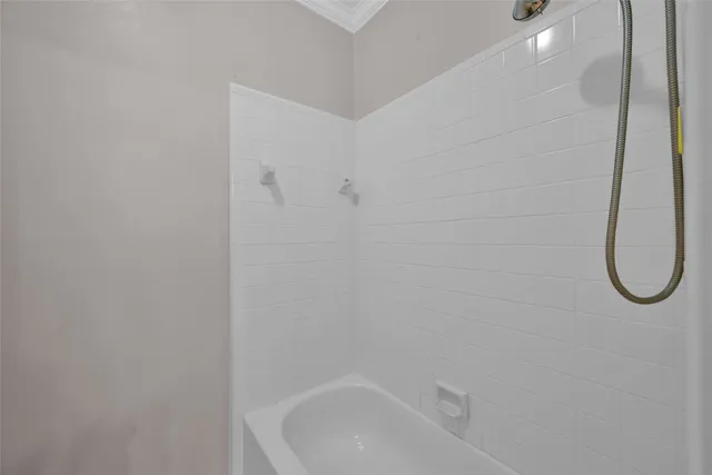 a bathroom with a bath tub with a shower