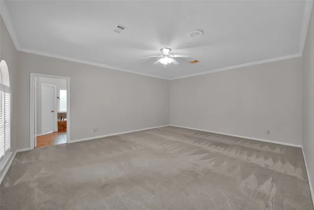a view of an empty room with a ceiling fan
