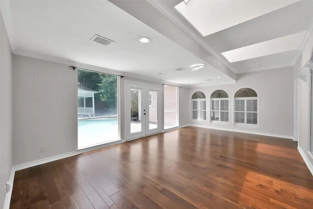 a view of an room with wooden floor and windows