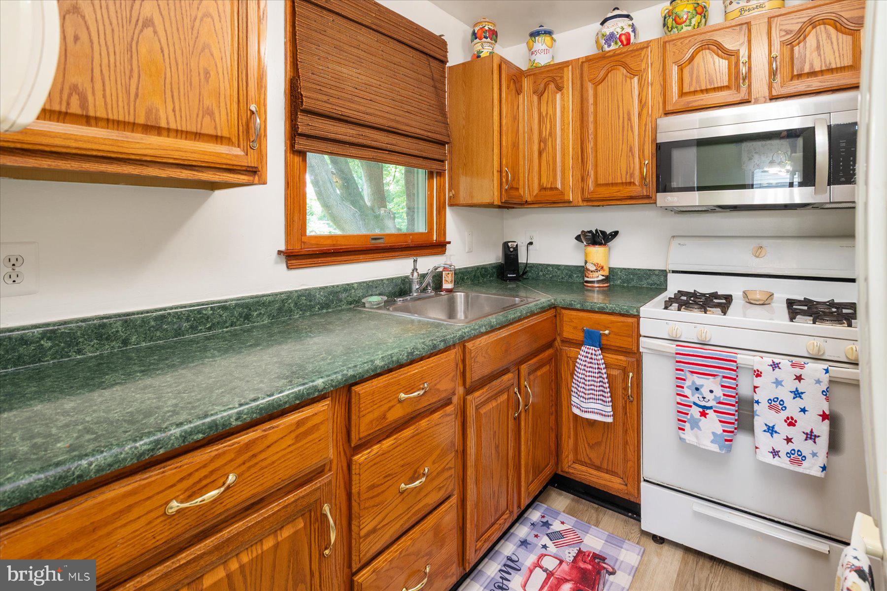 19 Old Tollgate Road Owings Mills, MD 21117 - Photo 11 of 37 a kitchen with stainless steel appliances granite countertop a sink stove and microwave